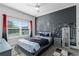 Bedroom with city skyline wall mural, a comfy bed, and ample natural light at 4297 Paragraph Dr, Kissimmee, FL 34746