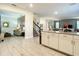 Modern kitchen with white cabinets and view into living area at 4633 Target Blvd, Kissimmee, FL 34746