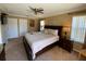 Spacious bedroom with king-size bed and ceiling fan at 467 La Mirage St, Davenport, FL 33897