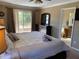 King-size bed, ensuite bathroom access, and TV at 467 La Mirage St, Davenport, FL 33897