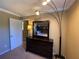 Bedroom with dresser, mirror, and floor lamp at 467 La Mirage St, Davenport, FL 33897
