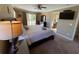 King-size bed, ensuite bathroom access, and TV at 467 La Mirage St, Davenport, FL 33897
