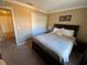 King-size bed in a well-lit bedroom with double doors at 467 La Mirage St, Davenport, FL 33897