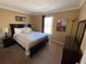 King-size bed in a spacious bedroom with ample natural light at 467 La Mirage St, Davenport, FL 33897
