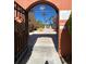 Ornate entrance gate to community with courtyard view and palm trees at 467 La Mirage St, Davenport, FL 33897