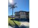 Two-story townhome with attractive landscaping and a paved driveway at 467 La Mirage St, Davenport, FL 33897