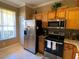 Kitchen boasting stainless steel appliances and wood cabinets at 467 La Mirage St, Davenport, FL 33897
