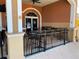 Outdoor patio seating area with metal fencing at 467 La Mirage St, Davenport, FL 33897