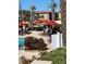 Relaxing pool deck with red umbrellas and lounge chairs at 467 La Mirage St, Davenport, FL 33897