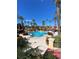 Large resort-style pool with palm trees and blue sky at 467 La Mirage St, Davenport, FL 33897