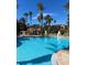 Expansive resort pool with palm trees and clear water at 467 La Mirage St, Davenport, FL 33897