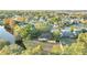 Aerial view showing a yellow house near a lake and other homes at 4814 Jeanette Ct, Saint Cloud, FL 34771