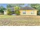 Back of house showing a yellow house with a screened patio at 4814 Jeanette Ct, Saint Cloud, FL 34771