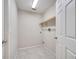 Simple laundry room with tile flooring and shelving at 4814 Jeanette Ct, Saint Cloud, FL 34771