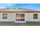 House back view, showcasing sliding glass doors and yard at 652 Mesilla Dr, Kissimmee, FL 34758