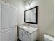 Bathroom with granite countertop and single sink vanity at 7959 Delwin Ln, Kissimmee, FL 34747