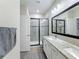 Modern bathroom with double vanity, granite countertop and large shower at 7959 Delwin Ln, Kissimmee, FL 34747