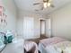 Bedroom with desk, chair, and pink fluffy bed at 7959 Delwin Ln, Kissimmee, FL 34747