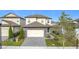 Two-story house with stone accents and a paved driveway at 7959 Delwin Ln, Kissimmee, FL 34747