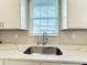 Kitchen sink and countertop with hexagonal tile backsplash at 7959 Delwin Ln, Kissimmee, FL 34747