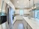 Bright kitchen featuring stainless steel refrigerator and white cabinetry at 7959 Delwin Ln, Kissimmee, FL 34747