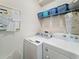 Laundry room with washer, dryer, and ample storage shelving at 7959 Delwin Ln, Kissimmee, FL 34747