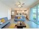 Open living area, gray sofa, and view of kitchen at 7959 Delwin Ln, Kissimmee, FL 34747