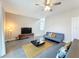 Living room with gray sofa and wood-look floors at 7959 Delwin Ln, Kissimmee, FL 34747