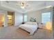 Bright main bedroom with king-size bed and ensuite bathroom access at 7959 Delwin Ln, Kissimmee, FL 34747