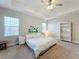Main bedroom with king-size bed, large windows and built-in shelving at 7959 Delwin Ln, Kissimmee, FL 34747