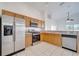 Kitchen features stainless steel appliances and light wood cabinets at 913 Cassia Dr, Davenport, FL 33897