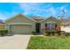 Attractive single-story house with a two-car garage and landscaped lawn at 1577 Diamond Loop, Kissimmee, FL 34744