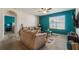 Living room with teal accent wall and access to bedroom at 1577 Diamond Loop, Kissimmee, FL 34744