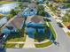 Elevated view of a two-story house with a driveway and landscaping in a neighborhood setting at 1079 Berkeley Dr, Kissimmee, FL 34744