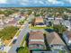 Aerial view of a residential neighborhood with houses, pools, and a nearby lake at 1079 Berkeley Dr, Kissimmee, FL 34744