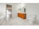 Bathroom with wood vanity, toilet, and view of adjacent bedroom at 1079 Berkeley Dr, Kissimmee, FL 34744