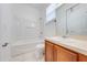 Clean bathroom with a combination tub/shower, white toilet, and wood vanity at 1079 Berkeley Dr, Kissimmee, FL 34744