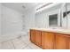 Clean bathroom with double vanity, tiled floors, and shower/tub combo at 1079 Berkeley Dr, Kissimmee, FL 34744