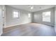 Spacious bedroom with laminate wood flooring, large window, and neutral gray walls at 1079 Berkeley Dr, Kissimmee, FL 34744