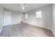 Spacious bedroom with laminate wood flooring, large window, and neutral gray walls at 1079 Berkeley Dr, Kissimmee, FL 34744