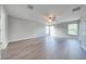 Large bedroom with wood laminate flooring, multiple windows, and neutral gray walls at 1079 Berkeley Dr, Kissimmee, FL 34744