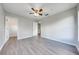 Spacious bedroom with laminate wood flooring, walk-in closet, and neutral gray walls at 1079 Berkeley Dr, Kissimmee, FL 34744