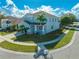 Light blue two-story home with a palm tree in the front yard and a covered lanai in the back at 1079 Berkeley Dr, Kissimmee, FL 34744