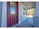 Front door with decorative glass and a welcome mat, leading to a covered porch at 1079 Berkeley Dr, Kissimmee, FL 34744