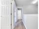 Hallway with wood-look flooring and white doors at 1079 Berkeley Dr, Kissimmee, FL 34744