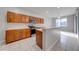 Bright kitchen with wood cabinetry, stainless appliances, and a breakfast bar at 1079 Berkeley Dr, Kissimmee, FL 34744