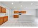 Spacious kitchen with ample wood cabinets, stainless steel appliances, breakfast bar, and tile flooring at 1079 Berkeley Dr, Kissimmee, FL 34744