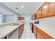 Kitchen with stainless steel appliances, ample counter space, wooden cabinets, and white tile floor at 1079 Berkeley Dr, Kissimmee, FL 34744