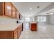 Large kitchen with wood cabinets, a breakfast bar, and an adjacent dining area at 1079 Berkeley Dr, Kissimmee, FL 34744