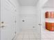 Laundry room with wire shelving and tile floor at 1079 Berkeley Dr, Kissimmee, FL 34744